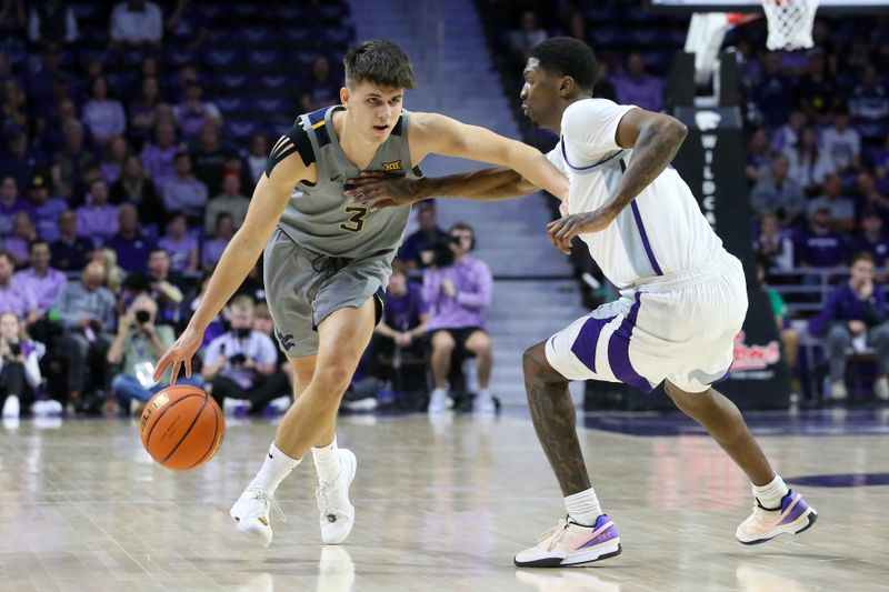 Feb 26, 2024; Manhattan, Kansas, USA; West Virginia Mountaineers guard Kerr Kriisa (3) dribbles against Kansas State Wildcats guard Cam Carter (5) during the second half at Bramlage Coliseum. Mandatory Credit: Scott Sewell-USA TODAY Sports