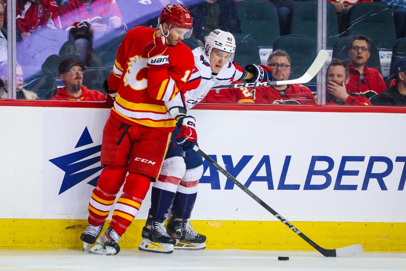 Mar 18, 2024; Calgary, Alberta, CAN; Washington Capitals left wing Beck Malenstyn (47) and Calgary Flames center Jonathan Huberdeau (10) battles for the puck during the first period at Scotiabank Saddledome. Mandatory Credit: Sergei Belski-USA TODAY Sports