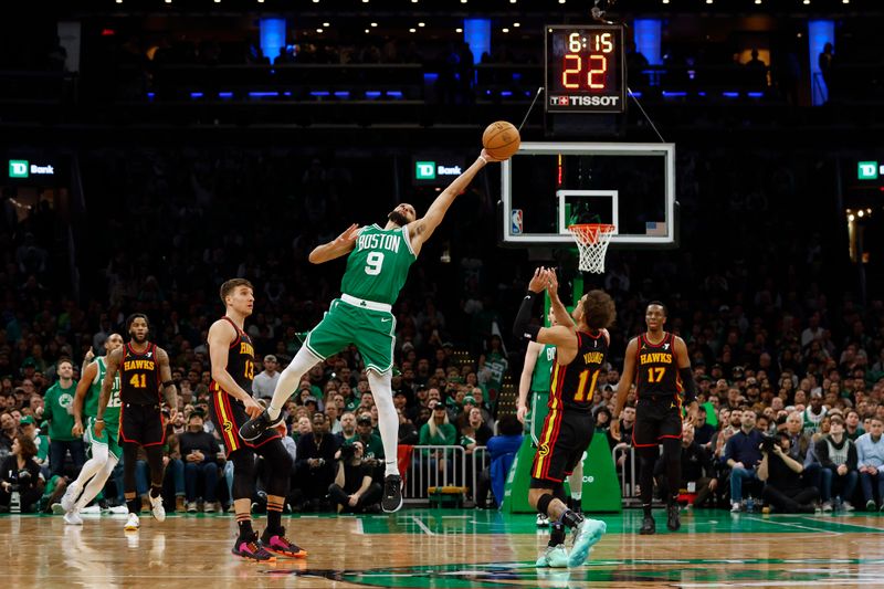 BOSTON, MA - FEBRUARY 7: Derrick White #9 of the Boston Celtics reaches for a loose ball over Trae Young #11 of the Atlanta Hawks during the second half at TD Garden on February 7, 2024 in Boston, Massachusetts. NOTE TO USER: User expressly acknowledges and agrees that, by downloading and/or using this Photograph, user is consenting to the terms and conditions of the Getty Images License Agreement. (Photo By Winslow Townson/Getty Images)