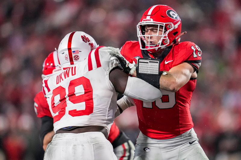 Nov 11, 2023; Athens, Georgia, USA; A Georgia Bulldogs tight end Brock Bowers (19) blocks against Mississippi Rebels defensive end Isaac Ukwu (99) during the second half at Sanford Stadium. Mandatory Credit: Dale Zanine-USA TODAY Sports