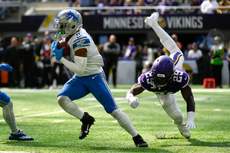 Detroit Lions wide receiver Kalif Raymond (11) runs from Minnesota Vikings cornerback Kris Boyd (29) during the first half of an NFL football game, Sunday, Sept. 25, 2022, in Minneapolis. (AP Photo/Craig Lassig)