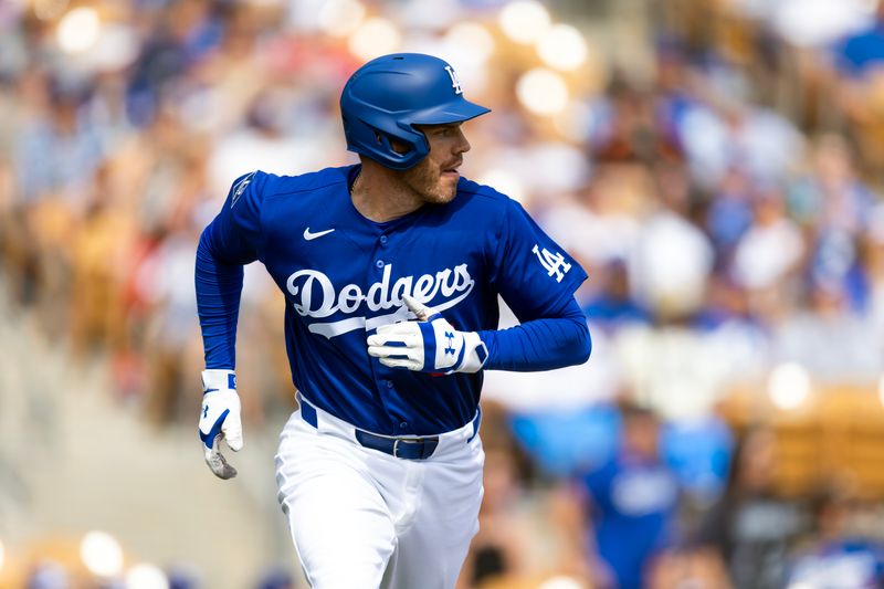 Mar 1, 2026; Phoenix, Arizona, USA; Los Angeles Dodgers first baseman Freddie Freeman hits a double against the Los Angeles Angels during a spring training game at Camelback Ranch-Glendale. Mandatory Credit: Mark J. Rebilas-Imagn Images
