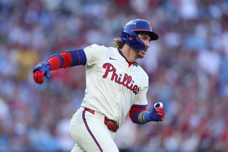 Oct 6, 2024; Philadelphia, Pennsylvania, USA; Philadelphia Phillies second base Bryson Stott (5) hits a single in the fourth inning against the New York Mets during game two of the NLDS for the 2024 MLB Playoffs at Citizens Bank Park. Mandatory Credit: Bill Streicher-Imagn Images