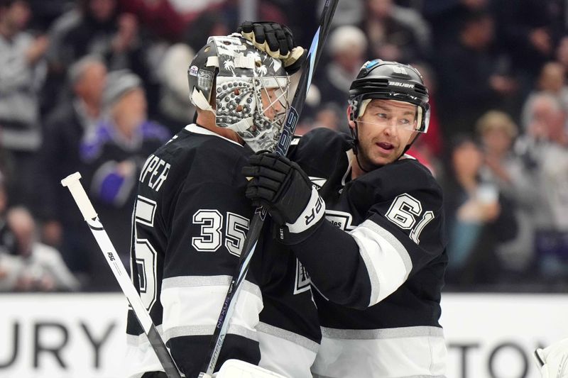 Jan 22, 2025; Los Angeles, California, USA; LA Kings goaltender Darcy Kuemper (35) and center Trevor Lewis (61) embrace after the game against the Florida Panthers at Crypto.com Arena. Mandatory Credit: Kirby Lee-Imagn Images