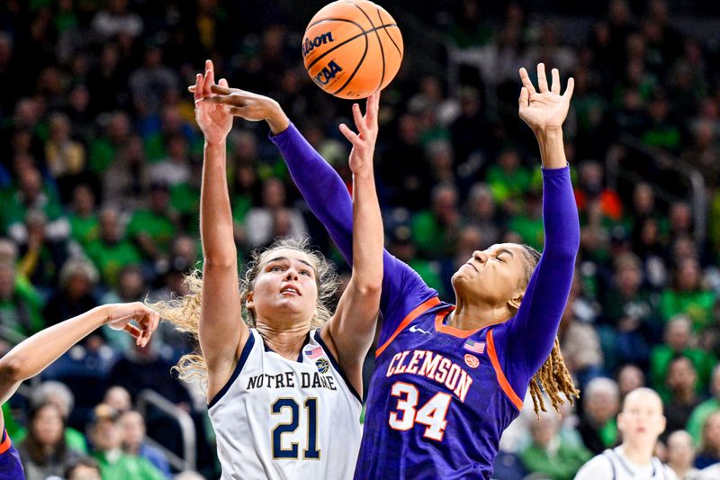 Feb 22, 2024; South Bend, Indiana, USA; Notre Dame Fighting Irish forward Maddy Westbeld (21) goes up for a shot as Clemson Tigers forward Amani Freeman (34) defends in the second half at the Purcell Pavilion. Mandatory Credit: Matt Cashore-USA TODAY Sports