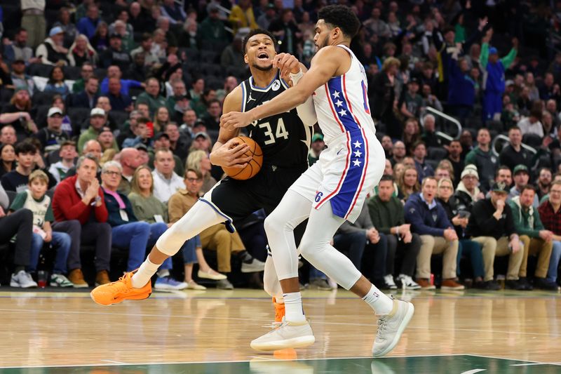 MILWAUKEE, WISCONSIN - MARCH 14: Giannis Antetokounmpo #34 of the Milwaukee Bucks is defended by Tobias Harris #12 of the Philadelphia 76ers during the first half of a game at Fiserv Forum on March 14, 2024 in Milwaukee, Wisconsin. NOTE TO USER: User expressly acknowledges and agrees that, by downloading and or using this photograph, User is consenting to the terms and conditions of the Getty Images License Agreement. (Photo by Stacy Revere/Getty Images)