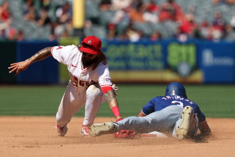 Sep 29, 2024; Anaheim, California, USA;  Texas Rangers center fielder Leody Taveras (3) steals second as Los Angeles Angels shortstop Jack Lopez (10) makes a tag during the seventh inning at Angel Stadium. Mandatory Credit: Kiyoshi Mio-Imagn Images