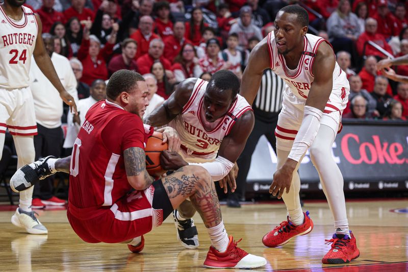 Jan 17, 2024; Piscataway, New Jersey, USA; Nebraska Cornhuskers guard C.J. Wilcher (0) and Rutgers Scarlet Knights forward Mawot Mag (3) battle for the ball in front of forward Aundre Hyatt (5) during the first half at Jersey Mike's Arena. Mandatory Credit: Vincent Carchietta-USA TODAY Sports