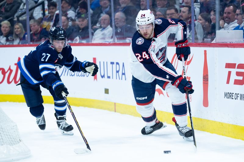 Jan 9, 2024; Winnipeg, Manitoba, CAN; Columbus Blue Jackets forward Mathieu Olivier (24) skates away from Winnipeg Jets forward Nikolaj Ehlers (27) during the first period at Canada Life Centre. Mandatory Credit: Terrence Lee-USA TODAY Sports