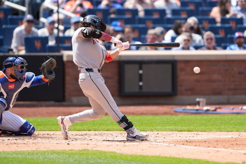 May 1, 2025; New York City, New York, USA; Arizona Diamondbacks center fielder Alek Thomas (5) hits a single against the New York Mets during the third inning at Citi Field. Mandatory Credit: Gregory Fisher-Imagn Images