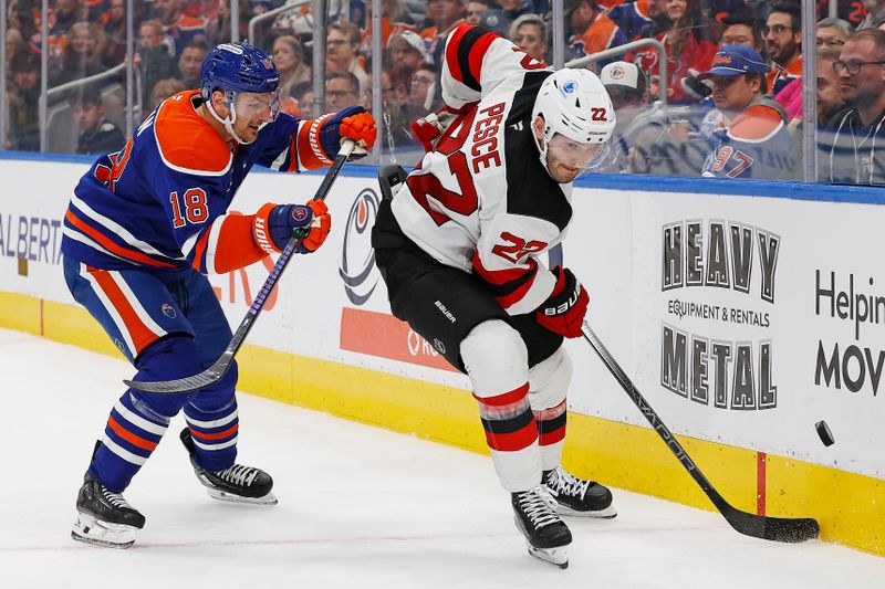 Nov 4, 2024; Edmonton, Alberta, CAN; New Jersey Devils defensemen Brett Pesce (22) and Edmonton Oilers forward Zach Hyman (18) battle along the boards for a loose puck  during the third period at Rogers Place. Mandatory Credit: Perry Nelson-Imagn Images