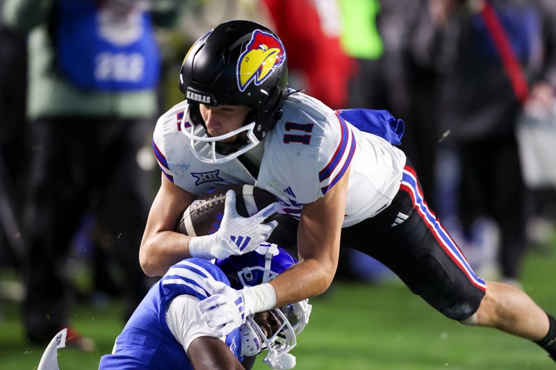 Nov 16, 2024; Provo, Utah, USA; Kansas Jayhawks wide receiver Luke Grimm (11) is tackled by Brigham Young Cougars cornerback Mory Bamba (4) during the second quarter at LaVell Edwards Stadium. Mandatory Credit: Rob Gray-Imagn Images