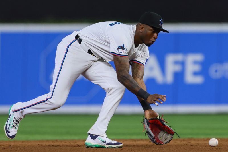 Jun 19, 2024; Miami, Florida, USA; Miami Marlins shortstop Tim Anderson (7) catches a ground ball against the St. Louis Cardinals during the ninth inning at loanDepot Park. Mandatory Credit: Sam Navarro-USA TODAY Sports