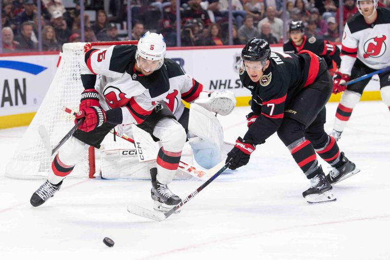 Oct 17, 2024; Ottawa, Ontario, CAN; New Jersey Devils defenseman Brendan Dillon (5) battles with Ottawa Senators left wing Brady Tkachuk (7) for control of the puck in the first period at the Canadian Tire Centre. Mandatory Credit: Marc DesRosiers-Imagn Images