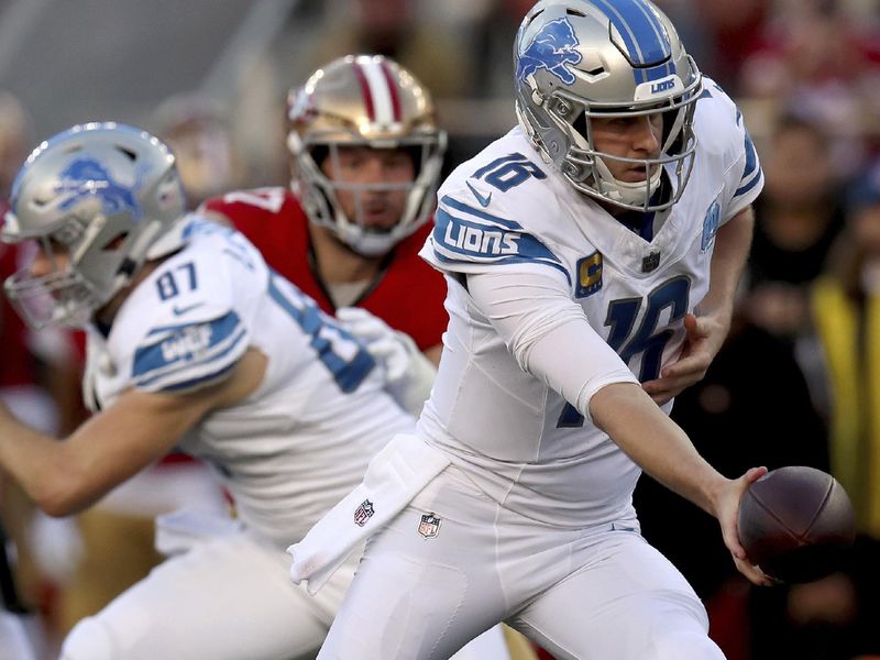 Detroit Lions quarterback Jared Goff (16) hands off the ball during the NFC Championship NFL football game against the San Francisco 49ers in Santa Clara, Calif., Sunday, Jan. 28, 2024. (AP Photo/Scot Tucker)