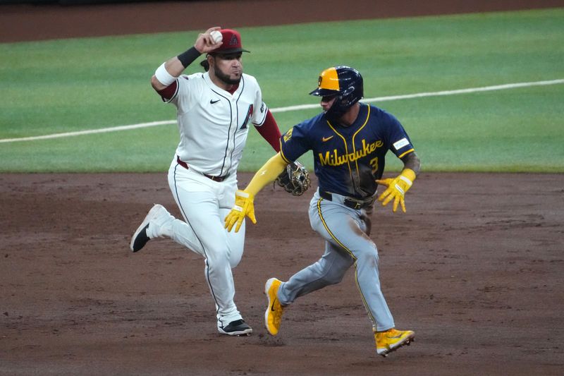 Sep 13, 2024; Phoenix, Arizona, USA; Arizona Diamondbacks third base Eugenio Suárez (28) runs down Milwaukee Brewers third base Joey Ortiz (3) during the fifth inning at Chase Field. Mandatory Credit: Joe Camporeale-Imagn Images