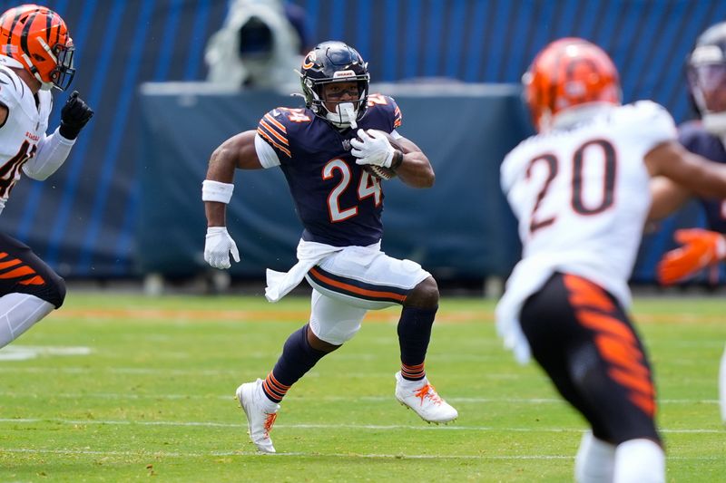 Chicago Bears running back Khalil Herbert (24) running with the ball during the first half of an NFL preseason football game against the Cincinnati Bengals, Saturday, Aug. 17, 2024, at Soldier Field in Chicago. (AP Photo/Charles Rex Arbogast)