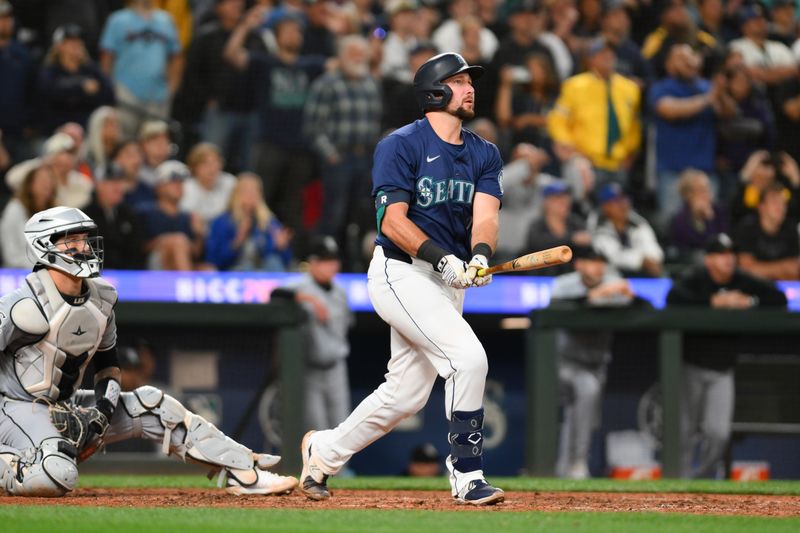 Jun 10, 2024; Seattle, Washington, USA; Seattle Mariners catcher Cal Raleigh (29) hits a walk-off grand slam against the Chicago White Sox during the ninth inning at T-Mobile Park. Mandatory Credit: Steven Bisig-USA TODAY Sports