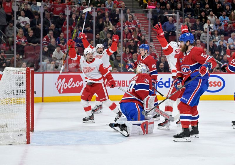 Apr 16, 2024; Montreal, Quebec, CAN; Detroit Red Wings forward Alex DeBrincat (93) celebrates a goal scored against Montreal Canadiens goalie Cayden Primeau (30) by teammate defenseman Moritz Seider (53) (not pictured) during the first period at the Bell Centre. Mandatory Credit: Eric Bolte-USA TODAY Sports