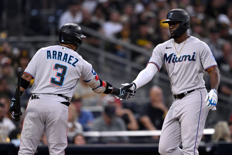 Aug 22, 2023; San Diego, California, USA; Miami Marlins designated hitter Jorge Soler (right) is congratulated by second baseman Luis Arraez (3) after hitting a home run against the San Diego Padres during the third inning at Petco Park. Mandatory Credit: Orlando Ramirez-USA TODAY Sports