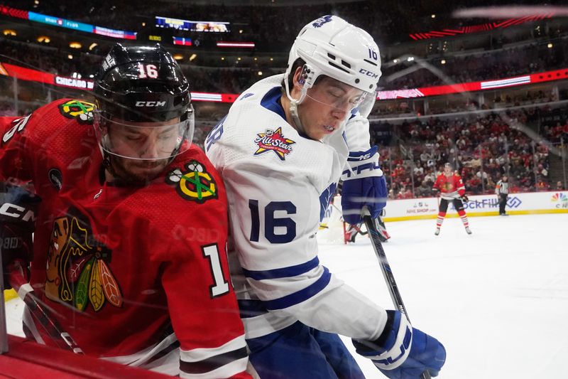 Nov 24, 2023; Chicago, Illinois, USA;Chicago Blackhawks center Jason Dickinson (16) and Toronto Maple Leafs right wing Mitchell Marner (16) go into the glass during the second period at United Center. Mandatory Credit: David Banks-USA TODAY Sports