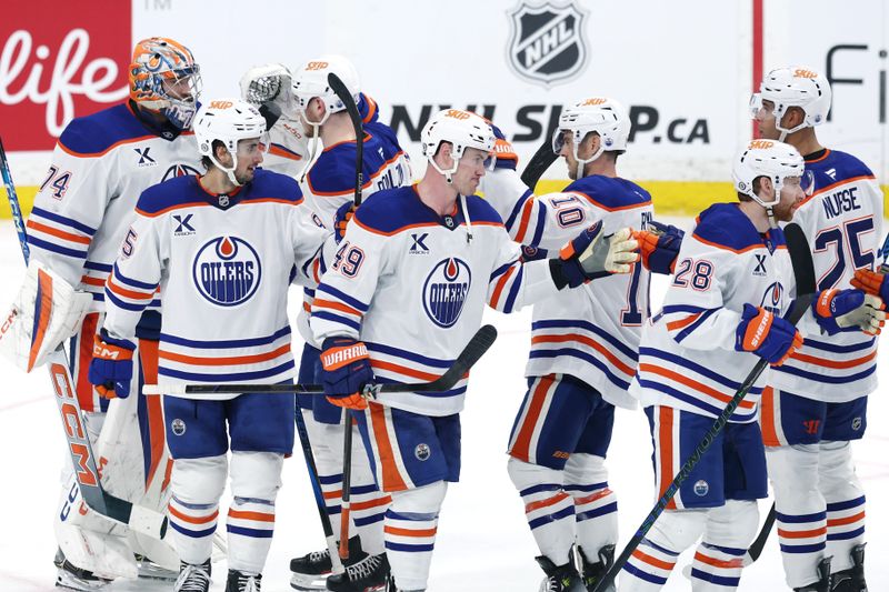 Apr 13, 2025; Winnipeg, Manitoba, CAN; Edmonton Oilers players celebrate their victory over the Winnipeg Jets at Canada Life Centre. Mandatory Credit: James Carey Lauder-Imagn Images