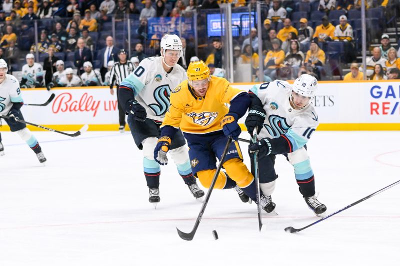 Oct 15, 2024; Nashville, Tennessee, USA;  Seattle Kraken center Matty Beniers (10) steals the puck from Nashville Predators center Jonathan Marchessault (81) during the first period at Bridgestone Arena. Mandatory Credit: Steve Roberts-Imagn Images