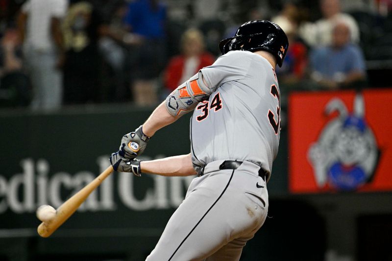 Jun 3, 2024; Arlington, Texas, USA; Detroit Tigers catcher Jake Rogers (34) hits the game winning home run against the Texas Rangers during the eighth inning at Globe Life Field. Mandatory Credit: Jerome Miron-USA TODAY Sports