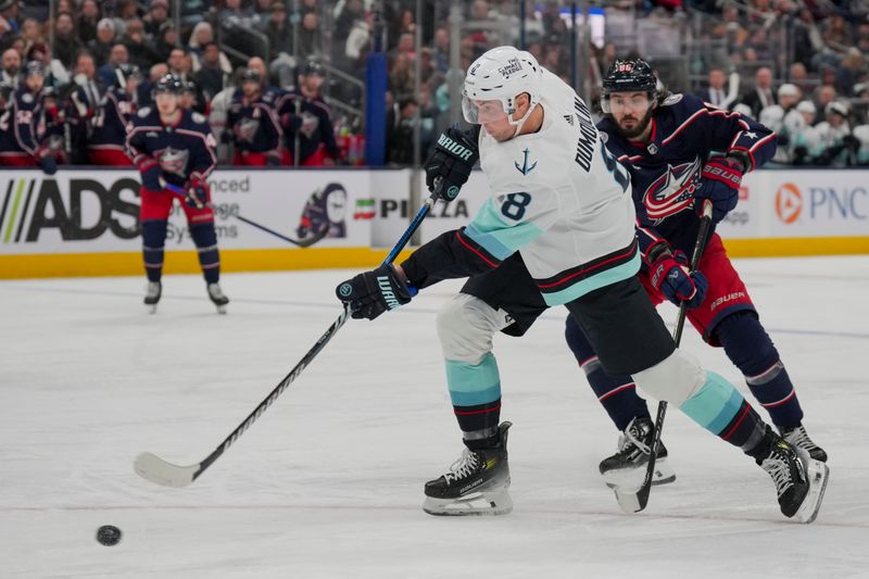 cJan 13, 2024; Columbus, Ohio, USA;  Seattle Kraken defenseman Brian Dumoulin (8) shoots the puck and scores a goal against the Columbus Blue Jackets in the third period at Nationwide Arena. Mandatory Credit: Aaron Doster-USA TODAY Sports