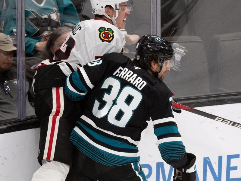 Oct 31, 2024; San Jose, California, USA; San Jose Sharks defenseman Mario Ferraro (38) checks Chicago Blackhawks defenseman Alex Vlasic (72) into the boards during the third period at SAP Center at San Jose. Mandatory Credit: D. Ross Cameron-Imagn Images