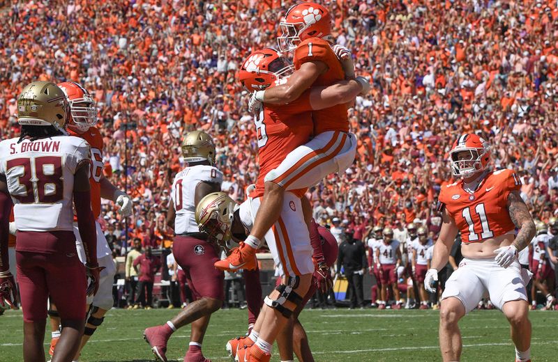 Sep 23, 2023; Clemson, South Carolina, USA; Clemson Tigers running back Will Shipley (1) celebrates with teammates after scoring against Florida State Seminoles defensive back Shyheim Brown (38) during the second quarter at Memorial Stadium. Mandatory Credit: Ken Ruinard-USA TODAY Sports