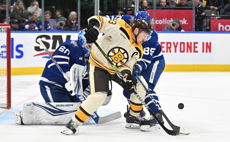 Dec 2, 2023; Toronto, Ontario, CAN; Boston Bruins forward Brad Marchand (63) tries to redirect a shot as Toronto Maple Leafs defenseman William Lagesson (85) and goalie Joseph Woll (60) defend in the second period at Scotiabank Arena. Mandatory Credit: Dan Hamilton-USA TODAY Sports