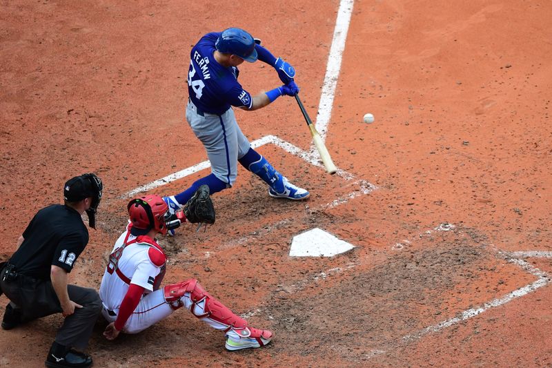 Jul 14, 2024; Boston, Massachusetts, USA;  Kansas City Royals catcher Freddy Fermin (34) hits an RBI single during the ninth inning against the Boston Red Sox at Fenway Park. Mandatory Credit: Bob DeChiara-USA TODAY Sports