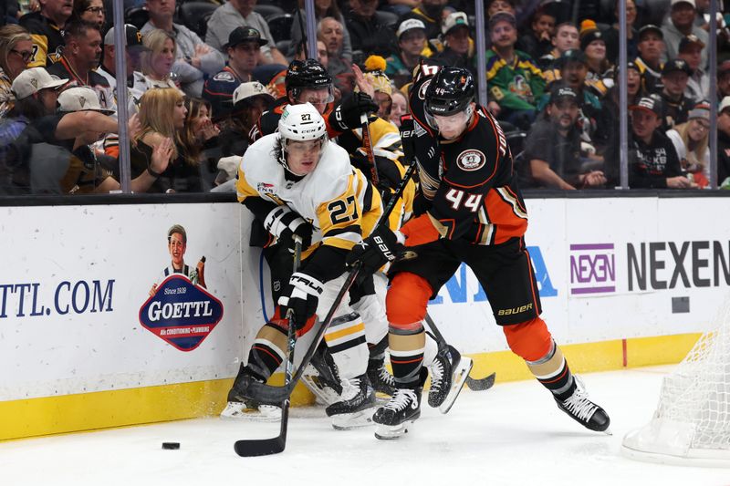 Nov 7, 2023; Anaheim, California, USA; Pittsburgh Penguins defenseman Ryan Graves (27) and Anaheim Ducks left wing Ross Johnston (44) fights for the puck during the second period at Honda Center. Mandatory Credit: Kiyoshi Mio-USA TODAY Sports