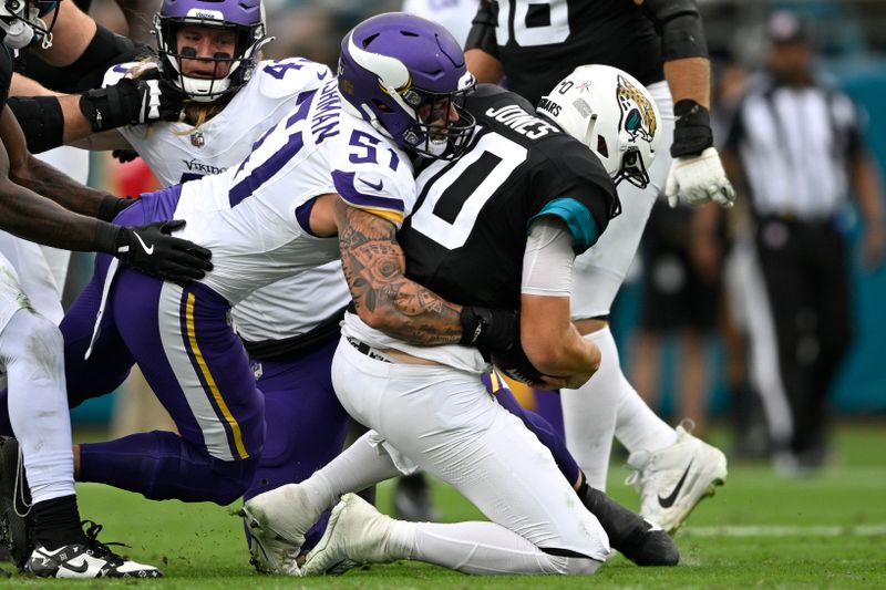 Jacksonville Jaguars quarterback Mac Jones (10) is sacked by Minnesota Vikings linebacker Blake Cashman (51) during the first half of an NFL football game, Sunday, Nov. 10, 2024, in Jacksonville, Fla. (AP Photo/Phelan M. Ebenhack)