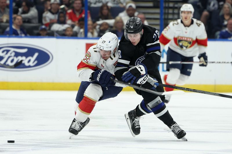 Feb 17, 2024; Tampa, Florida, USA;  Florida Panthers center Evan Rodrigues (17) and Tampa Bay Lightning defenseman Emil Martinsen Lilleberg (78) battle for the puck in the second period at Amalie Arena. Mandatory Credit: Nathan Ray Seebeck-USA TODAY Sports