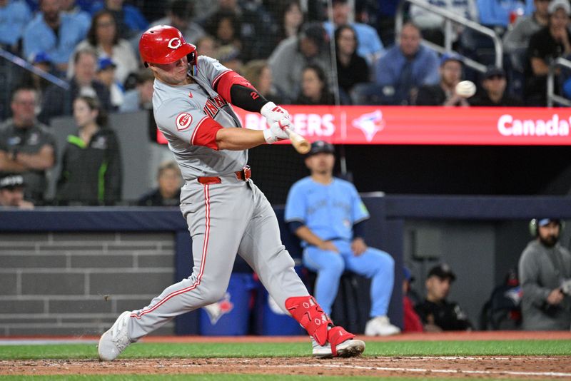 Aug 19, 2024; Toronto, Ontario, CAN; Cincinnati Reds first baseman Ty France (2) hits a two-RBI double against the Toronto Blue Jays in the sixth inning at Rogers Centre. Mandatory Credit: Dan Hamilton-USA TODAY Sports