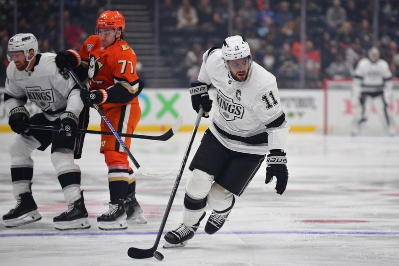 Nov 29, 2024; Anaheim, California, USA; Los Angeles Kings center Anze Kopitar (11) moves the puck against the Anaheim Ducks during the first period at Honda Center. Mandatory Credit: Gary A. Vasquez-Imagn Images