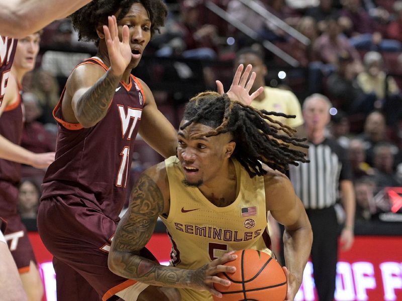 Jan 29, 2025; Tallahassee, Florida, USA; Florida State Seminoles guard DaQuan Davis (5) drives to the net past Virginia Tech Hokies guard Ben Hammond (11) during the first half at Donald L. Tucker Center. Mandatory Credit: Melina Myers-Imagn Images