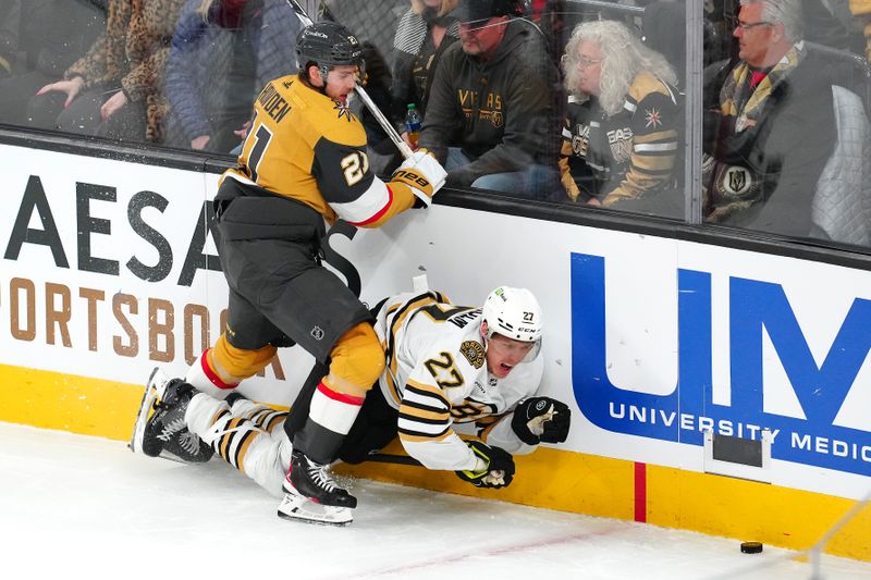 Jan 11, 2024; Las Vegas, Nevada, USA; Vegas Golden Knights center Brett Howden (21) checks Boston Bruins defenseman Hampus Lindholm (27) during the third period at T-Mobile Arena. Mandatory Credit: Stephen R. Sylvanie-USA TODAY Sports