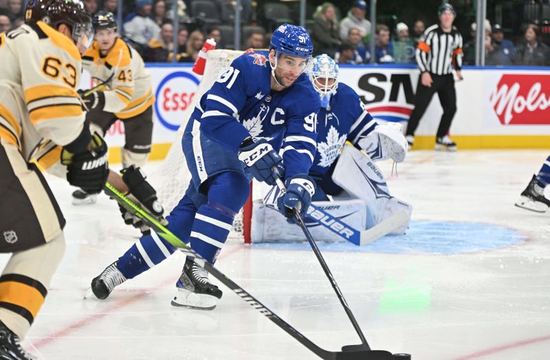 Dec 2, 2023; Toronto, Ontario, CAN; Toronto Maple Leafs forward John Tavares (91) takes a loose puck away from Boston Bruins forward Brad Marchand (63) in the second period at Scotiabank Arena. Mandatory Credit: Dan Hamilton-USA TODAY Sports