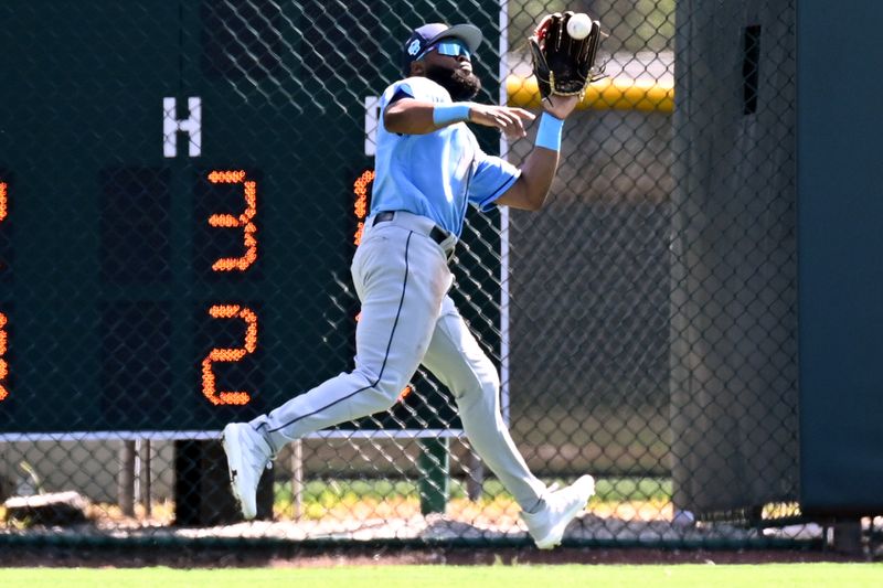 Feb 27, 2023; Sarasota, Florida, USA; Tampa Bay Rays center fielder Manuel Margot (13) catches a fly ball in the second inning against the Baltimore Orioles at Ed Smith Stadium. Mandatory Credit: Jonathan Dyer-USA TODAY Sports