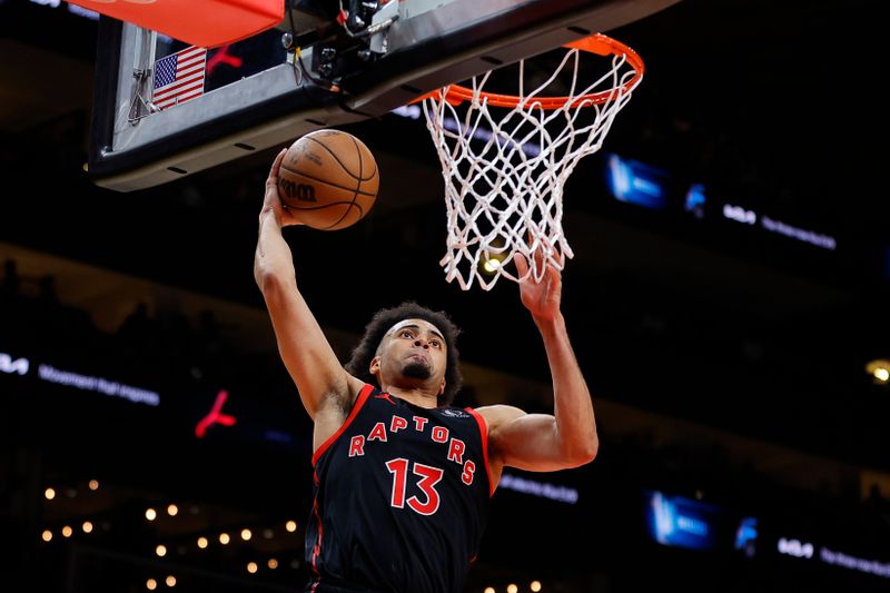 ATLANTA, GEORGIA - JANUARY 28: Jordan Nwora #13 of the Toronto Raptors dunks against the Atlanta Hawks during the second half at State Farm Arena on January 28, 2024 in Atlanta, Georgia. NOTE TO USER: User expressly acknowledges and agrees that, by downloading and or using this photograph, User is consenting to the terms and conditions of the Getty Images License Agreement. (Photo by Alex Slitz/Getty Images)