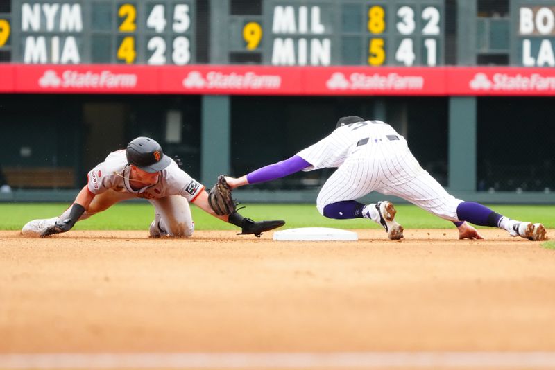 Jul 21, 2024; Denver, Colorado, USA; Colorado Rockies second base Aaron Schunk (30) tags out San Francisco Giants outfielder Tyler Fitzgerald (49) seventh inning at Coors Field. Mandatory Credit: Ron Chenoy-USA TODAY Sports