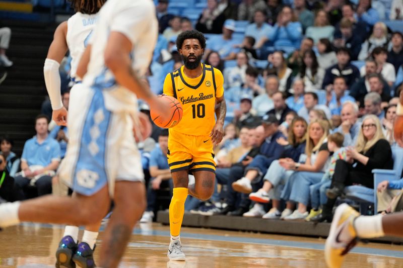 Jan 15, 2025; Chapel Hill, North Carolina, USA;  California Golden Bears guard Jovan Blacksher Jr. (10) brings the ball up the floor in the first half at Dean E. Smith Center. Mandatory Credit: Bob Donnan-Imagn Images