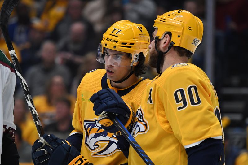 Nov 11, 2023; Nashville, Tennessee, USA; Nashville Predators center Ryan O'Reilly (90) talks with right wing Luke Evangelista (77) during the first period against the Arizona Coyotes at Bridgestone Arena. Mandatory Credit: Christopher Hanewinckel-USA TODAY Sports