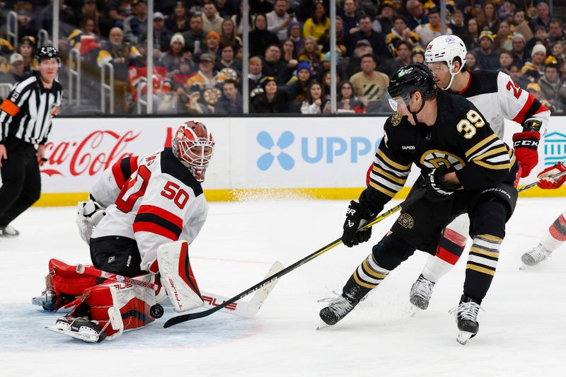 Jan 15, 2024; Boston, Massachusetts, USA; New Jersey Devils goaltender Nico Daws (50) stops Boston Bruins center Morgan Geekie (39) on a breakaway during the third period at TD Garden. Mandatory Credit: Winslow Townson-USA TODAY Sports