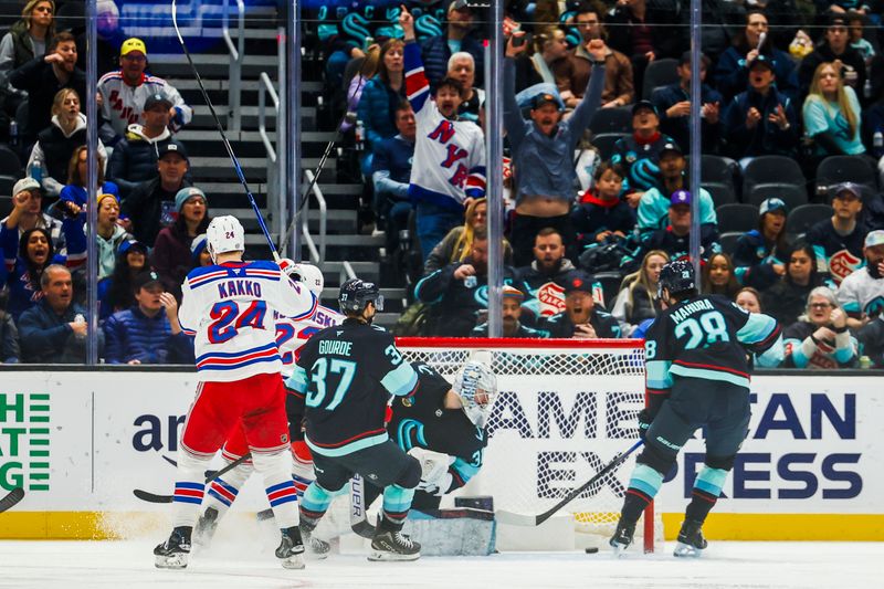 Nov 17, 2024; Seattle, Washington, USA; Seattle Kraken goaltender Philipp Grubauer (31, second from right) surrenders a goal to New York Rangers defenseman Zac Jones (6, not pictured) during the third period at Climate Pledge Arena. Mandatory Credit: Joe Nicholson-Imagn Images