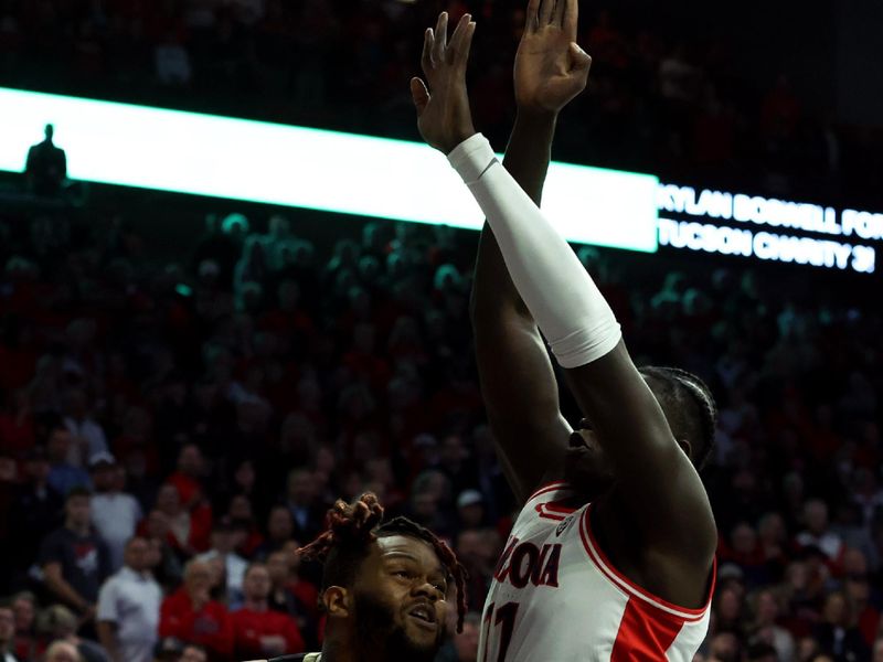 Jan 4, 2024; Tucson, Arizona, USA; Colorado Buffaloes center Eddie Lampkin Jr. (44) drives to the net against Arizona Wildcats center Oumar Ballo (11) during the first half at McKale Center. Mandatory Credit: Zachary BonDurant-USA TODAY Sports