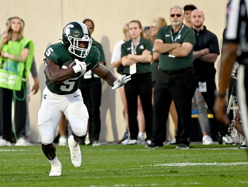 Sep 1, 2023; East Lansing, Michigan, USA;  Michigan State Spartans running back Nathan Carter (5) runs against the Central Michigan Chippewas in the second quarter at Spartan Stadium. Mandatory Credit: Dale Young-USA TODAY Sports